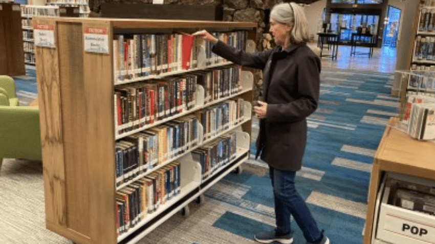 Woman exploring the Stacks at the Community Library