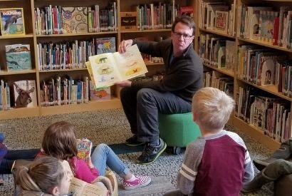 Craig Barry reading to kids during Story Time