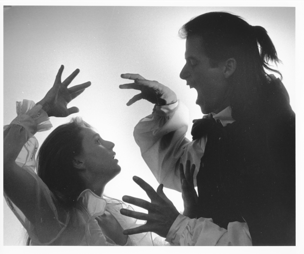 Two actors pose dramatically in a production of Dracula.