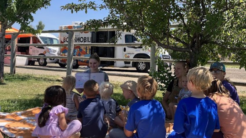 Lilianna reading at the Bookmobile