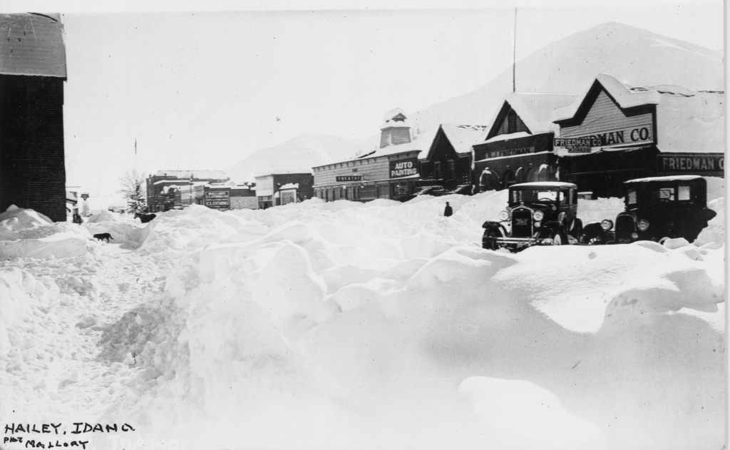 A town's main street buried in deep snow.